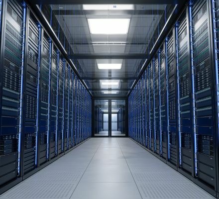 Data center hallway lined with server racks and steel tubing infrastructure.